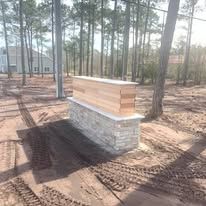 A wooden box is sitting in the middle of a forest.
