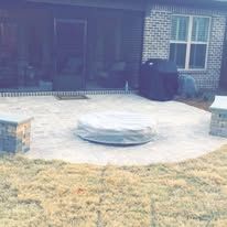 There is a fire pit in the middle of the patio.