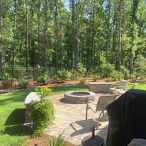 There is a fire pit in the middle of the backyard.