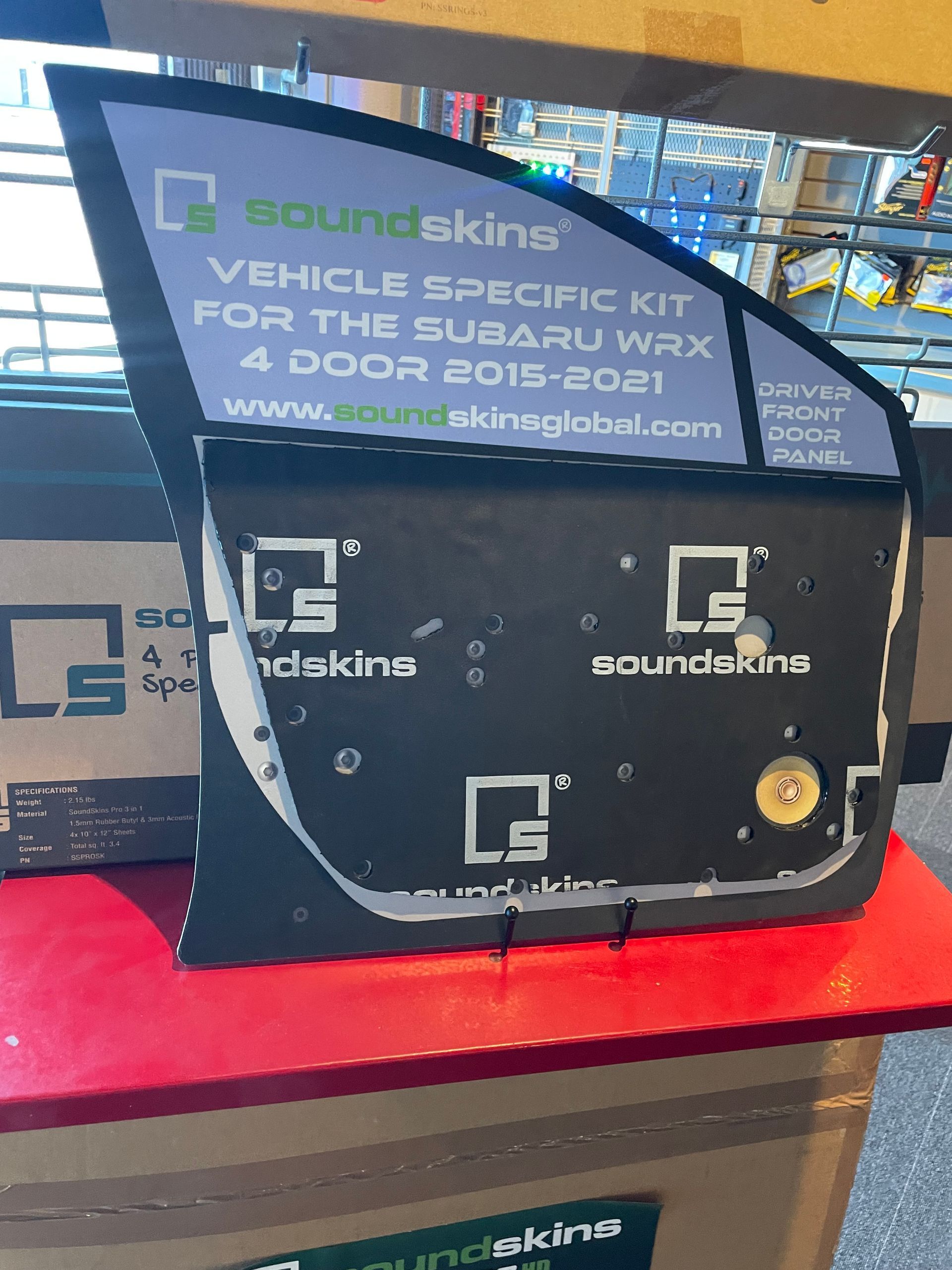 A SoundSkins vehicle-specific sound deadening kit for a 2015-2021 Subaru WRX 4-door, displayed on a red shelf.