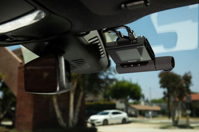 Dashcam mounted on a car's windshield, capturing the view outside