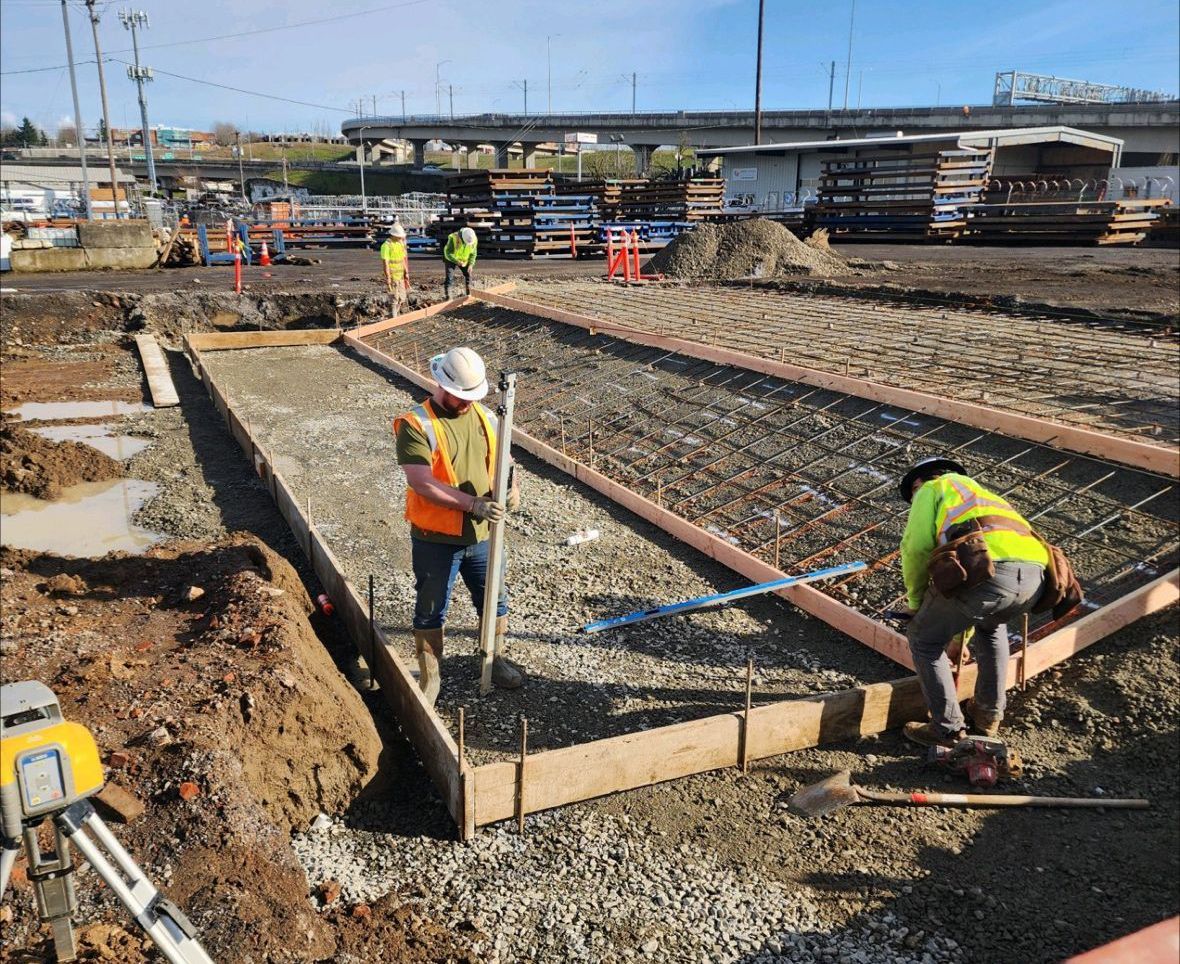 A group of construction workers are working on a construction site.