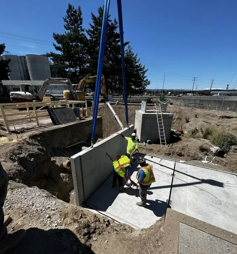 A group of construction workers are working on a concrete wall