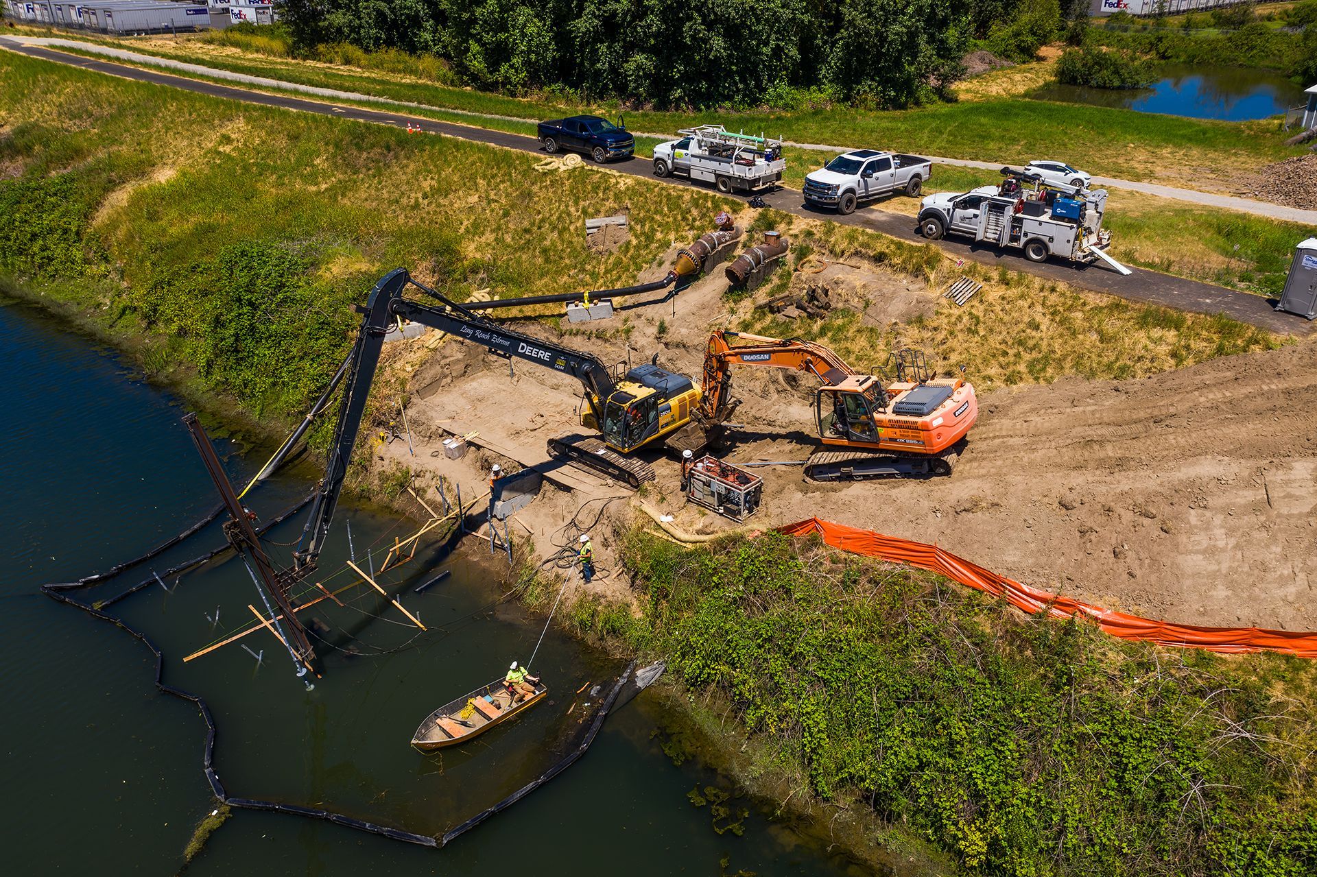 An aerial view of a construction site next to a body of water.
