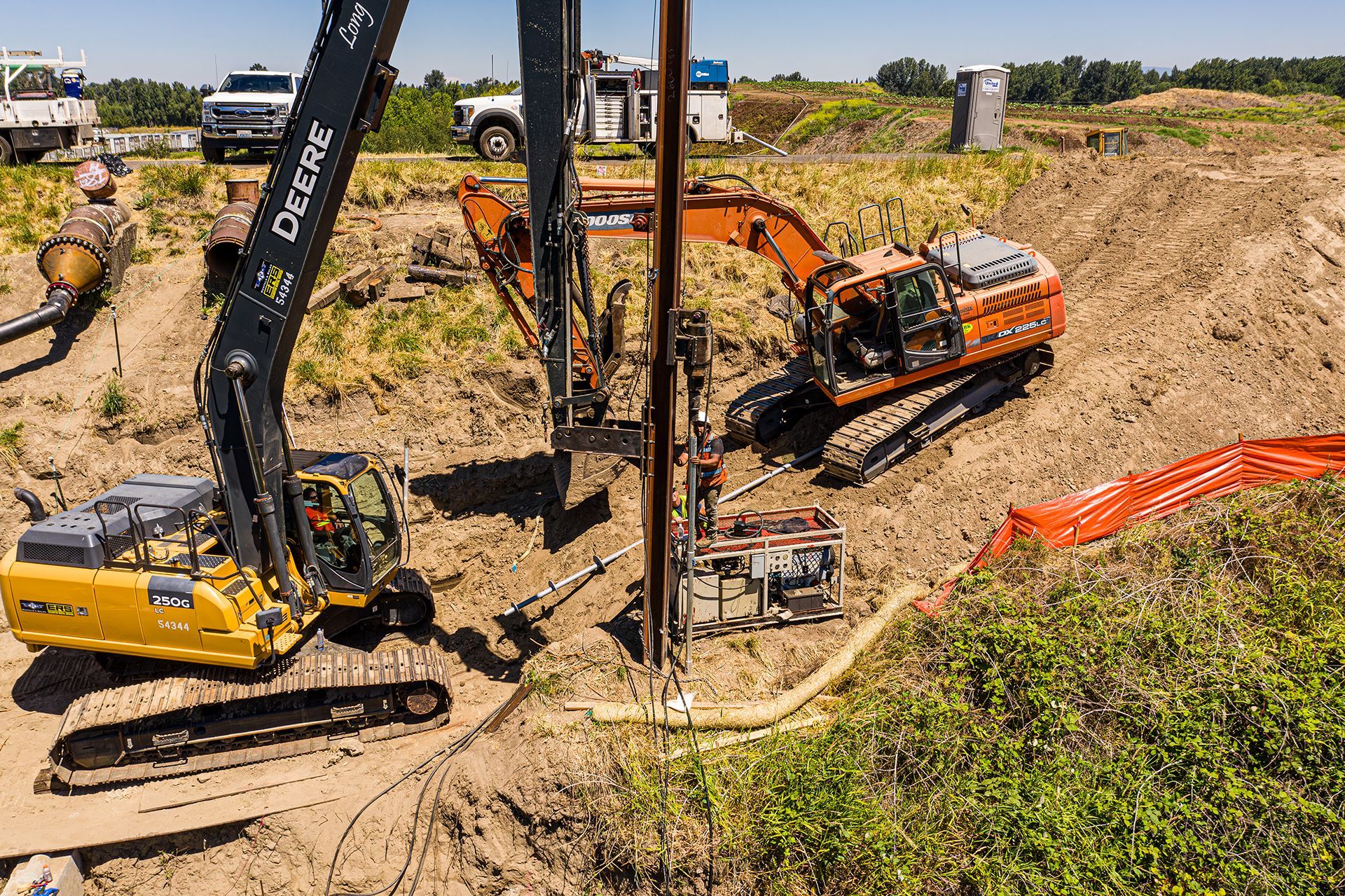 A group of construction vehicles are working on a construction site.