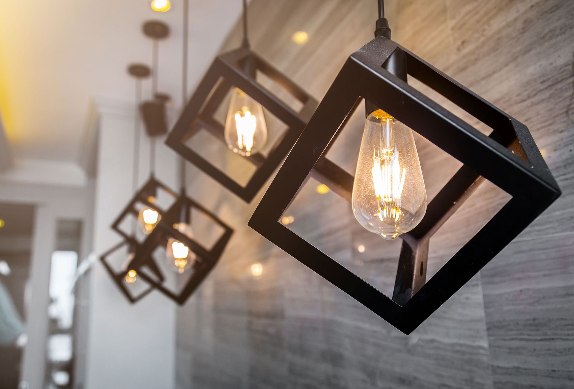 a group of pendant lights hanging from the ceiling in a room