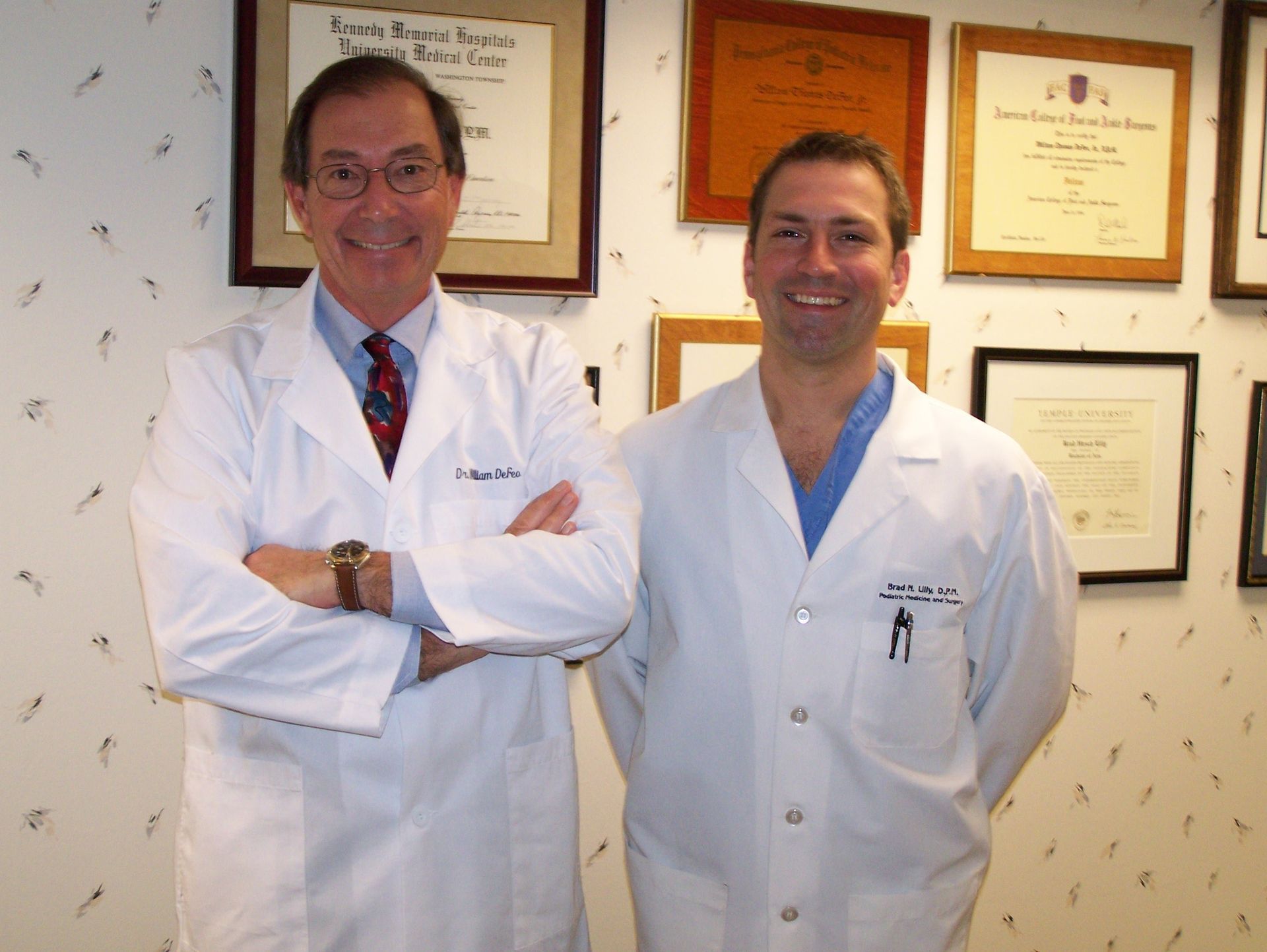 Two doctors standing next to each other with their arms crossed