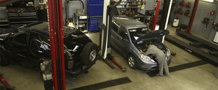 Two cars inside the shop