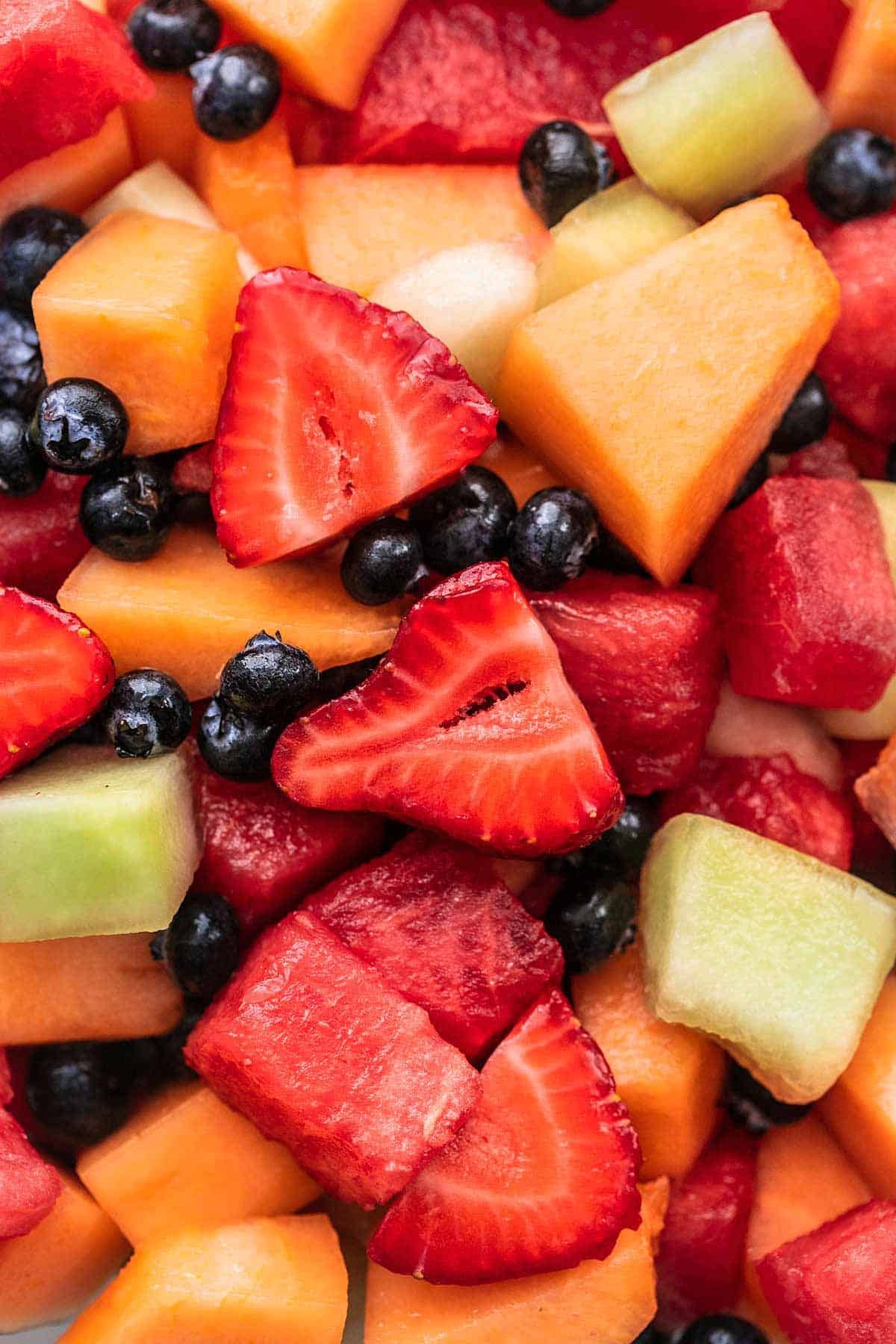 Fruit salad with strawberries, cantaloupe, watermelon, blueberries, and honeydew melon.
