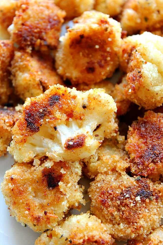 Close-up of crispy fried cauliflower bites with golden-brown breading.