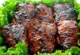Grilled dark meat, glazed, atop a bed of fresh green lettuce.
