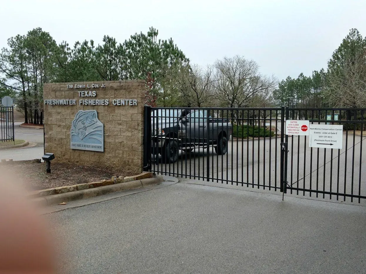 Entrance to Texas Highway Training Center with a truck parked behind the gate.