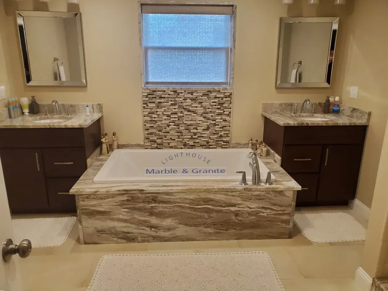 Bathroom with double vanity, bathtub, and neutral color scheme.