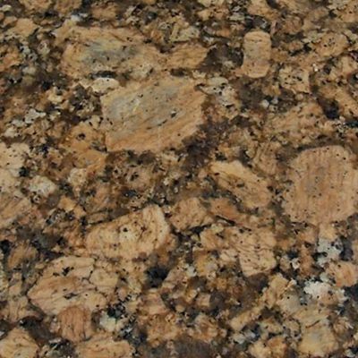 Close-up of golden brown granite countertop with dark speckles and large stone-like patterns.