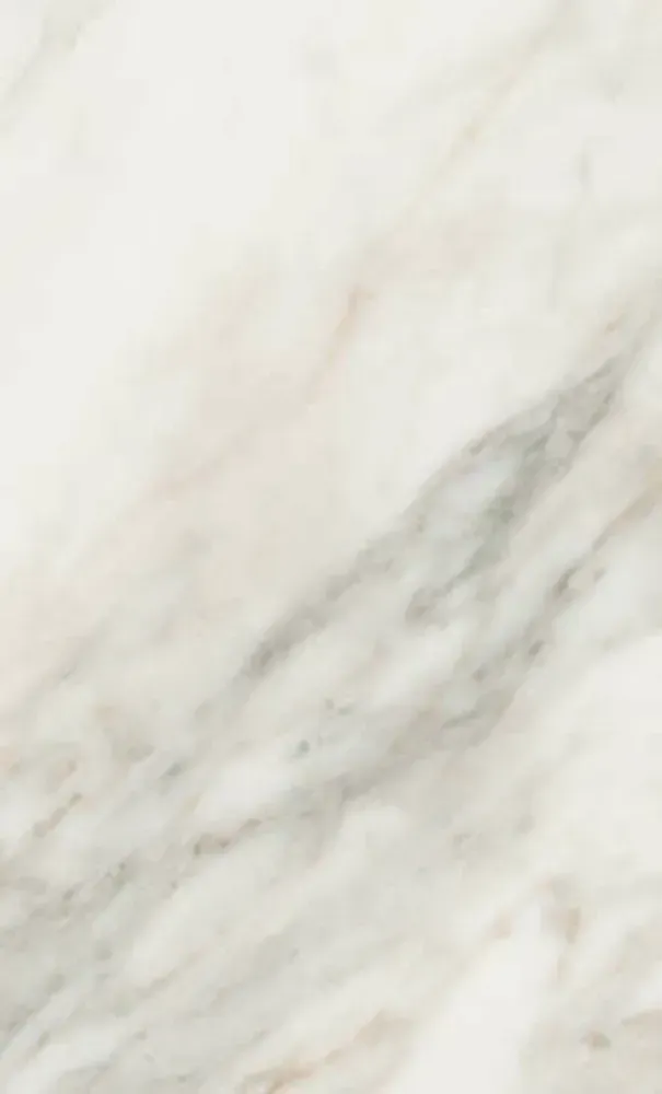 White marble surface with gray and pink veining.