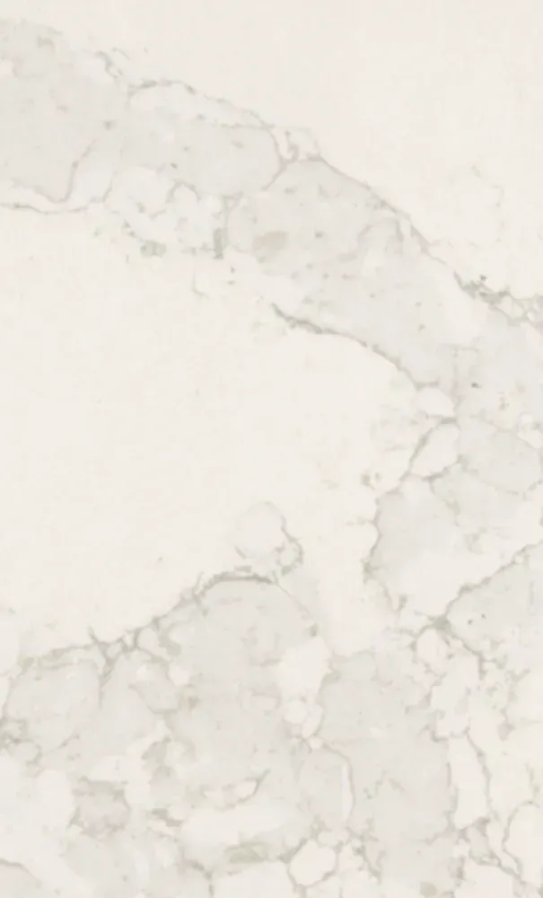 Off-white marble with gray veining, potentially used as a countertop or wall.