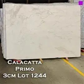 Calacatta Primo marble slab, 3cm, lot 1244, light gray with darker veining, stacked on a pallet.