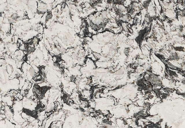 Close-up of a white and gray marbled countertop with swirls and veining patterns.