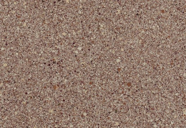 Textured surface, speckled with various shades of brown and beige.