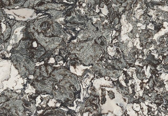 Close-up of a speckled granite-like surface with swirling gray, white, and brown patterns.