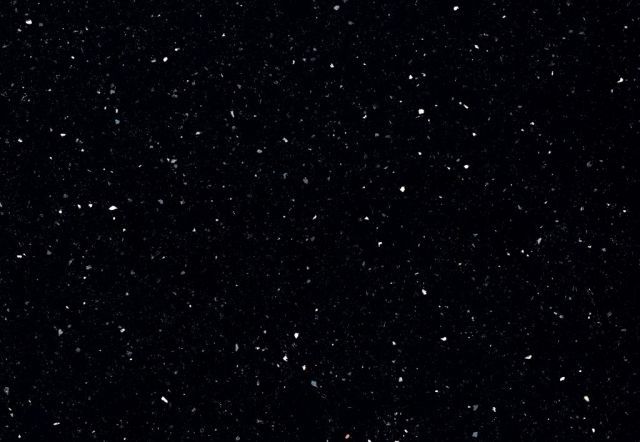 Dark background with many tiny, bright specks, like a night sky with stars.