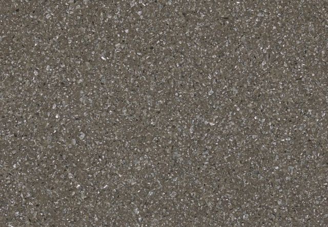 Textured surface, grayish-brown with tiny reflective particles, possibly granite or a similar material.