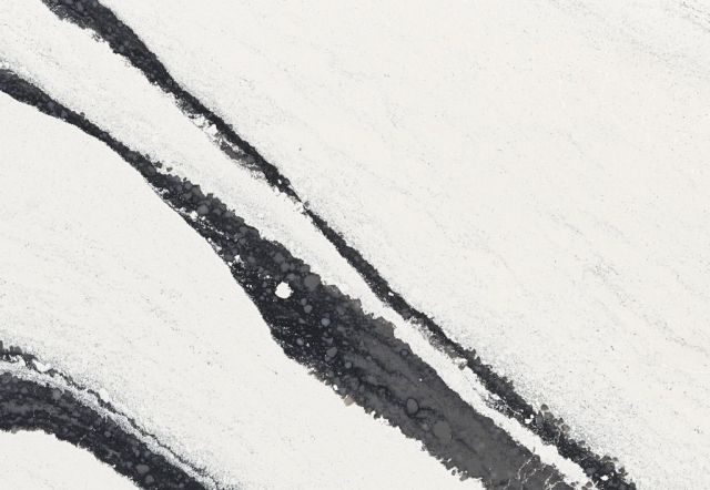 White countertop with dark gray diagonal veining.