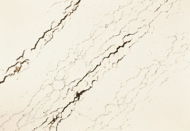 Cream-colored marble with dark, jagged veining patterns across the surface.