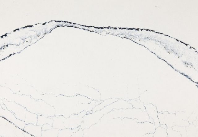 White countertop with dark blue veining, resembling a river or coastline.