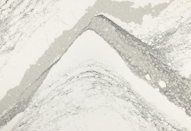Close-up of a white and gray veined countertop with a sharp, angular design.