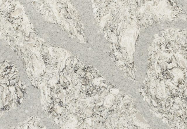 White and gray speckled stone surface with irregular, flowing patterns.