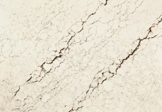 Cream-colored surface with dark cracks and veins; resembles marble or stone texture.