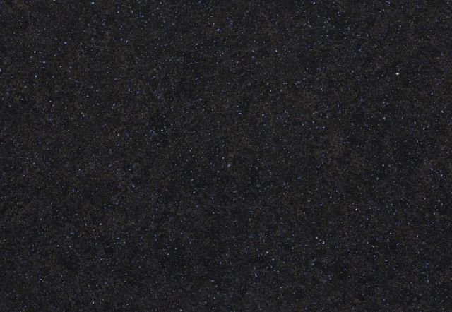 Dark gray, textured surface with tiny white flecks.