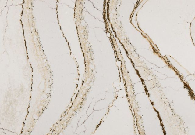 White countertop with brown, wavy veining.