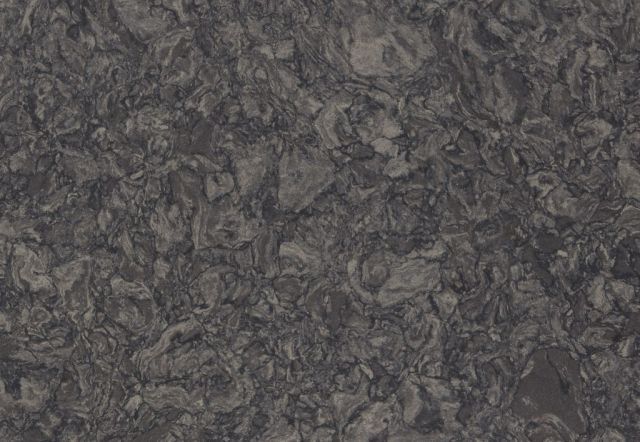 Dark gray, textured surface with layered patterns resembling a rock formation.