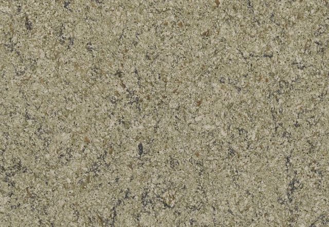 Close-up of a rough, light tan stone surface with darker flecks and a speckled texture.