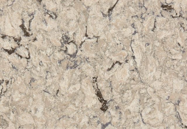Close-up of beige and cream quartz countertop with dark grey veining.