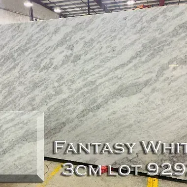 Fantasy White granite slab with gray and white veining; a showroom setting.