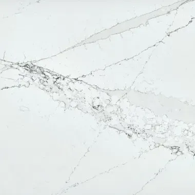 White countertop with gray veining, resembling marble.