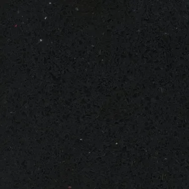 Close-up of a rough, dark black surface with tiny flecks of other colors.