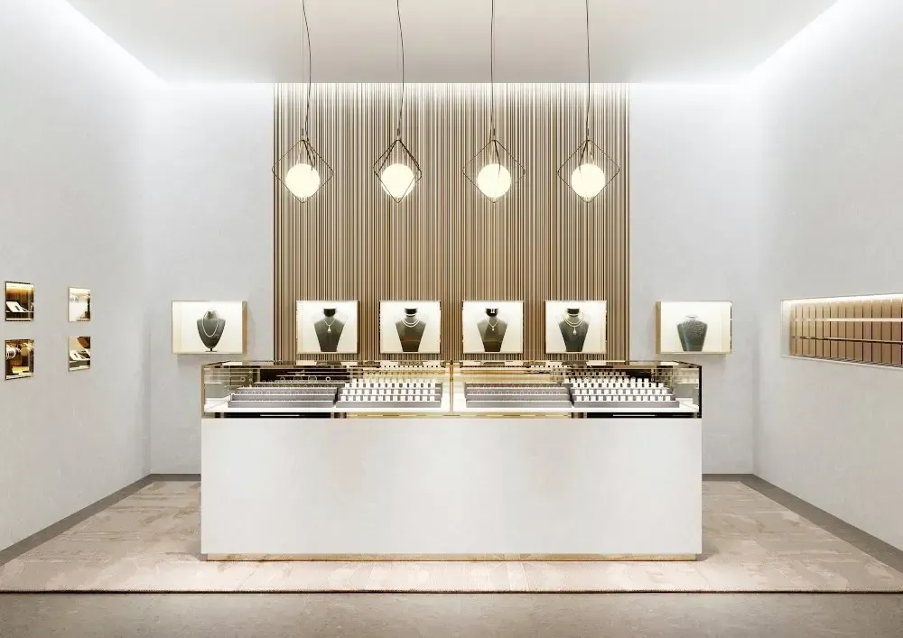 Jewelry store interior with white walls, display cases, and draped backdrop, featuring necklace displays and pendant lights.