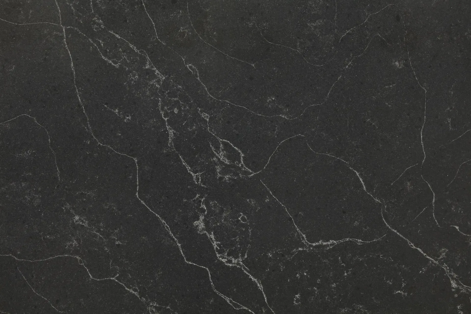 Dark grey stone surface with white veining.