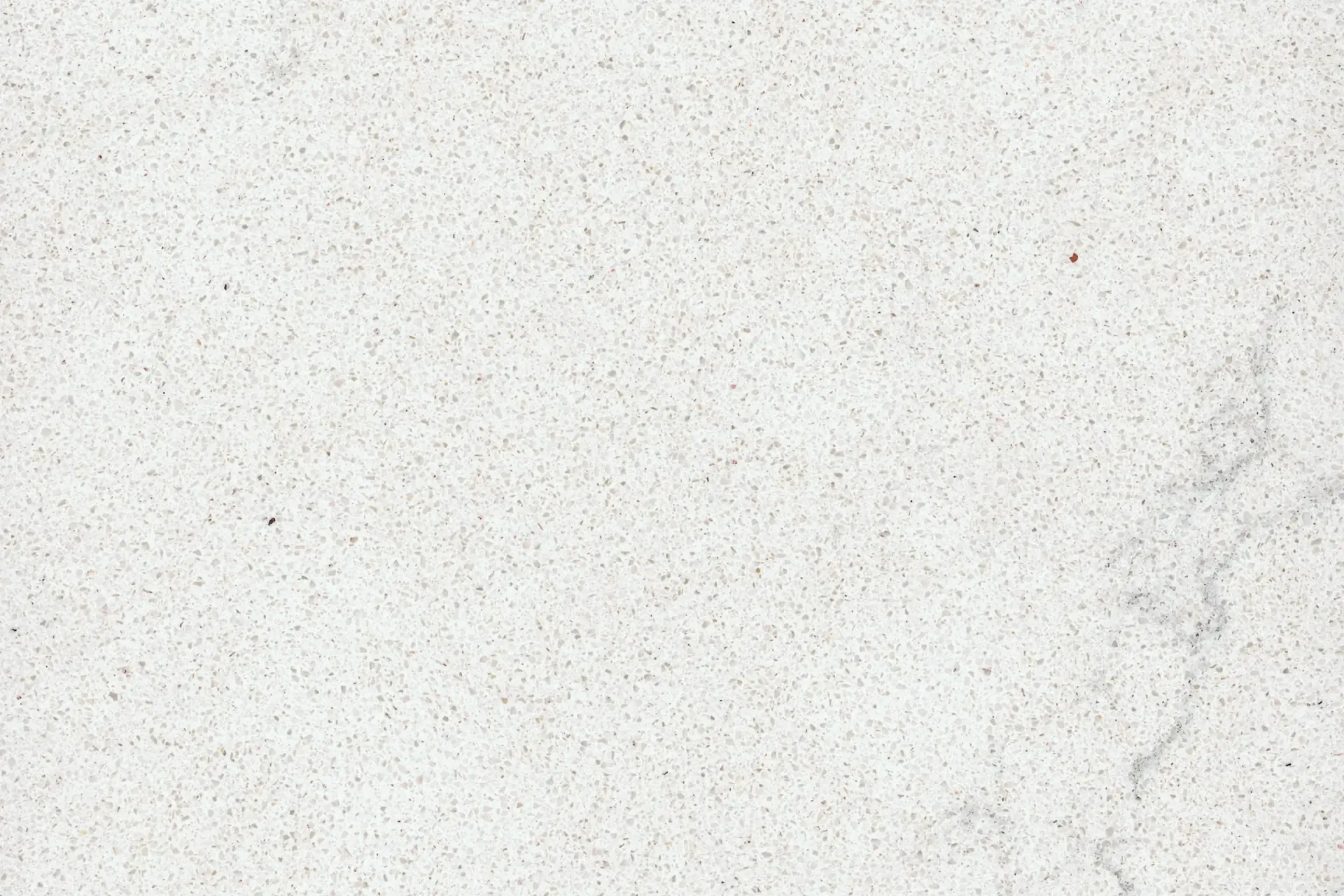 Off-white textured surface with subtle speckles and a faint water stain on the right.