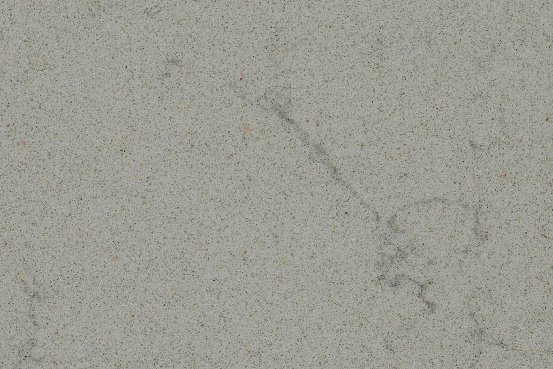 Light grey, speckled concrete surface with a darker, slightly blurred streak across it.
