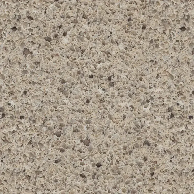 Close-up of a speckled quartz countertop in shades of beige and gray.