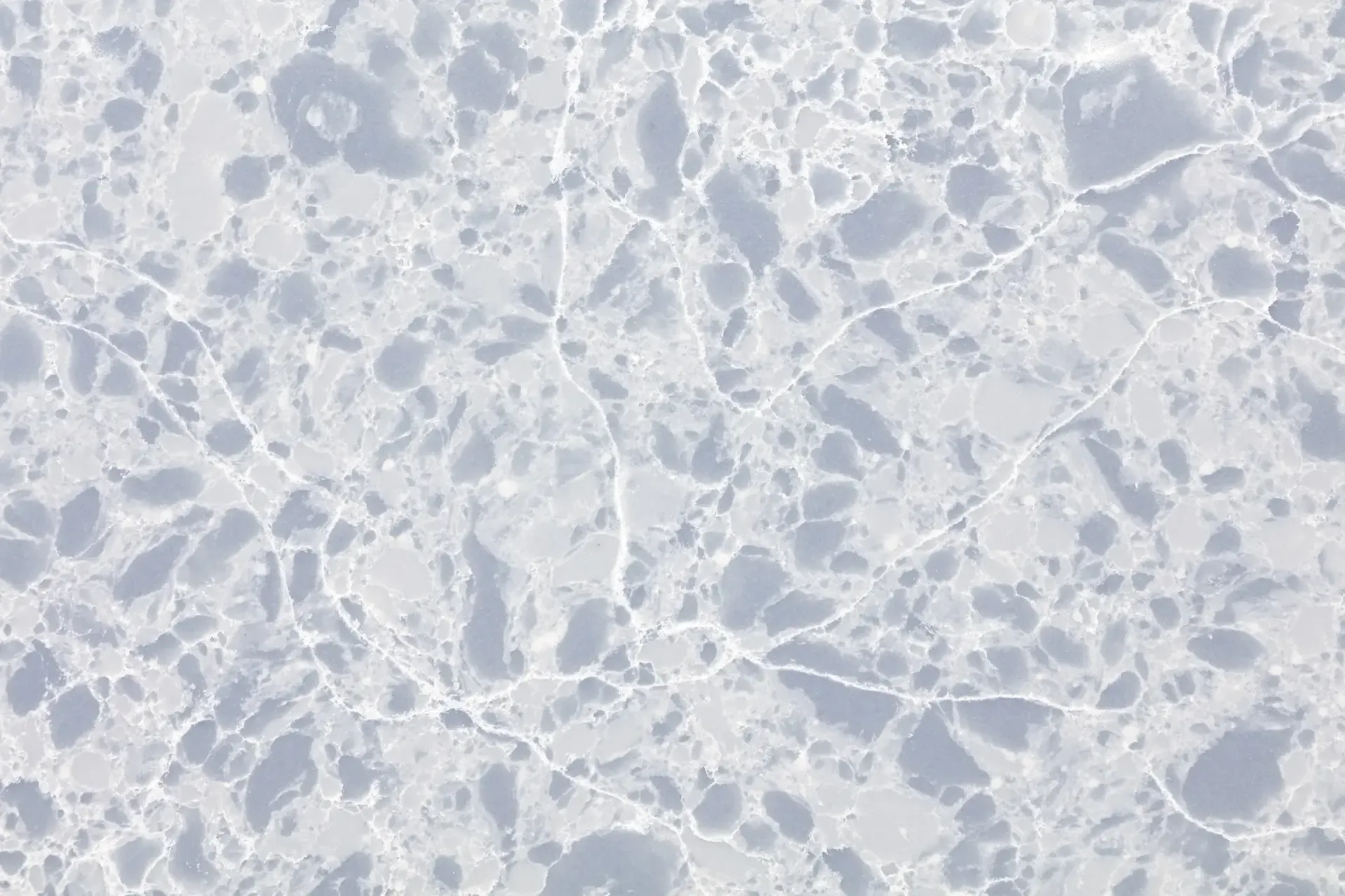 Cracked ice, white and gray with shadows.