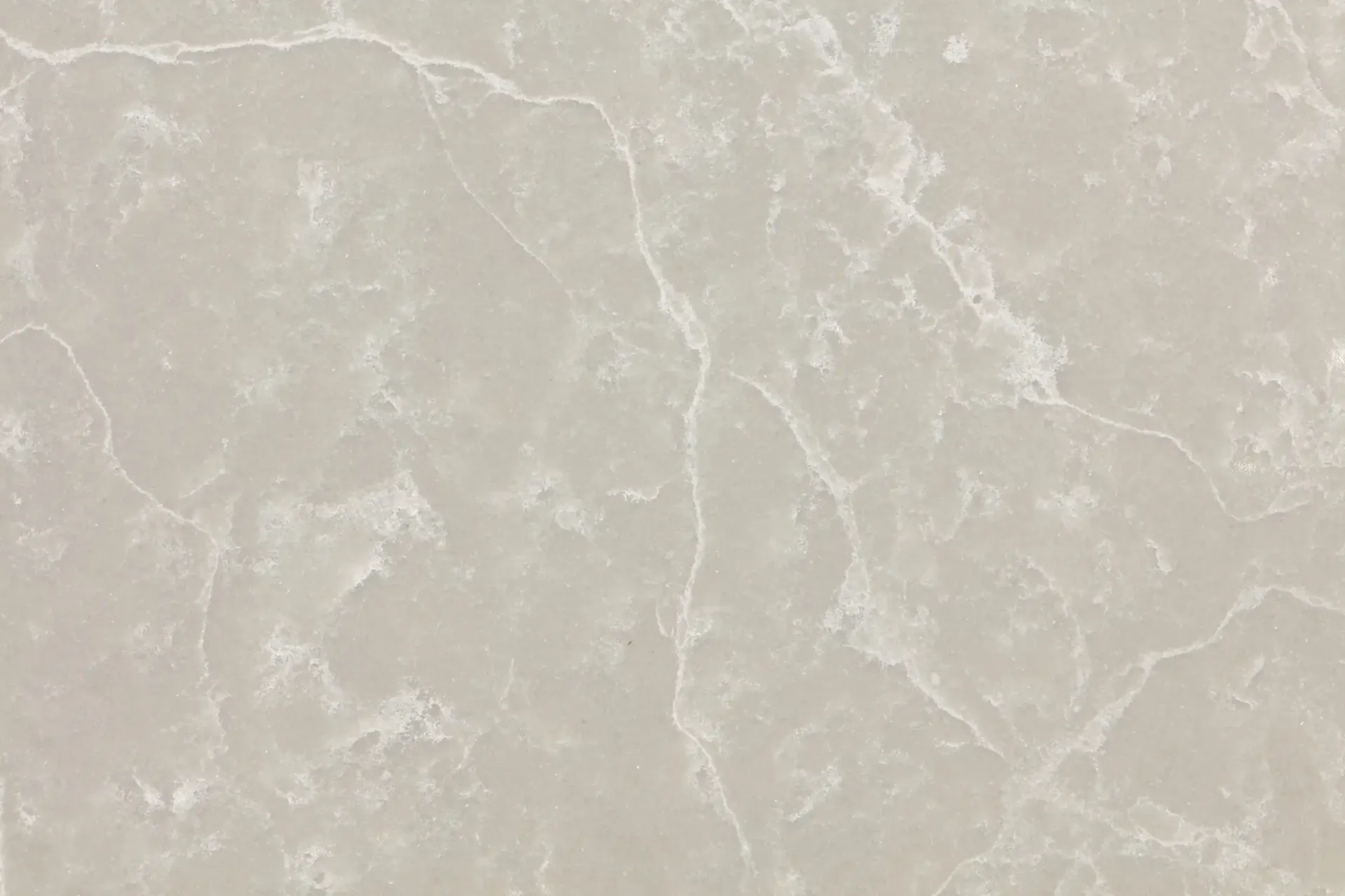 Beige countertop with white veining, resembling marble.