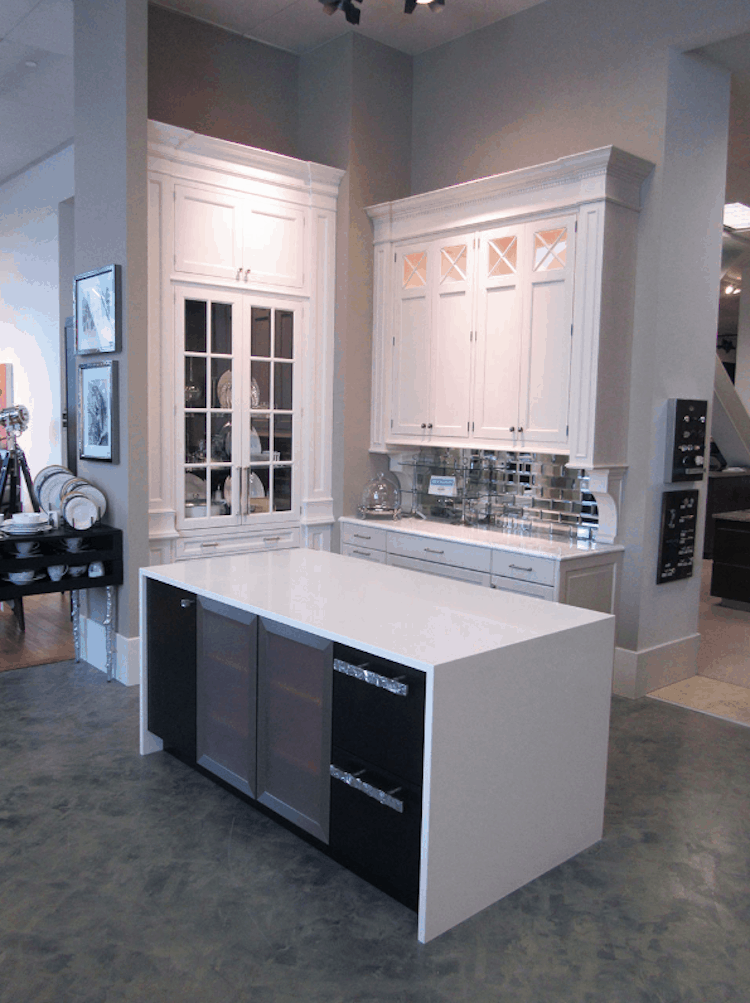 Kitchen with white cabinets, island, and appliances; neutral tones.