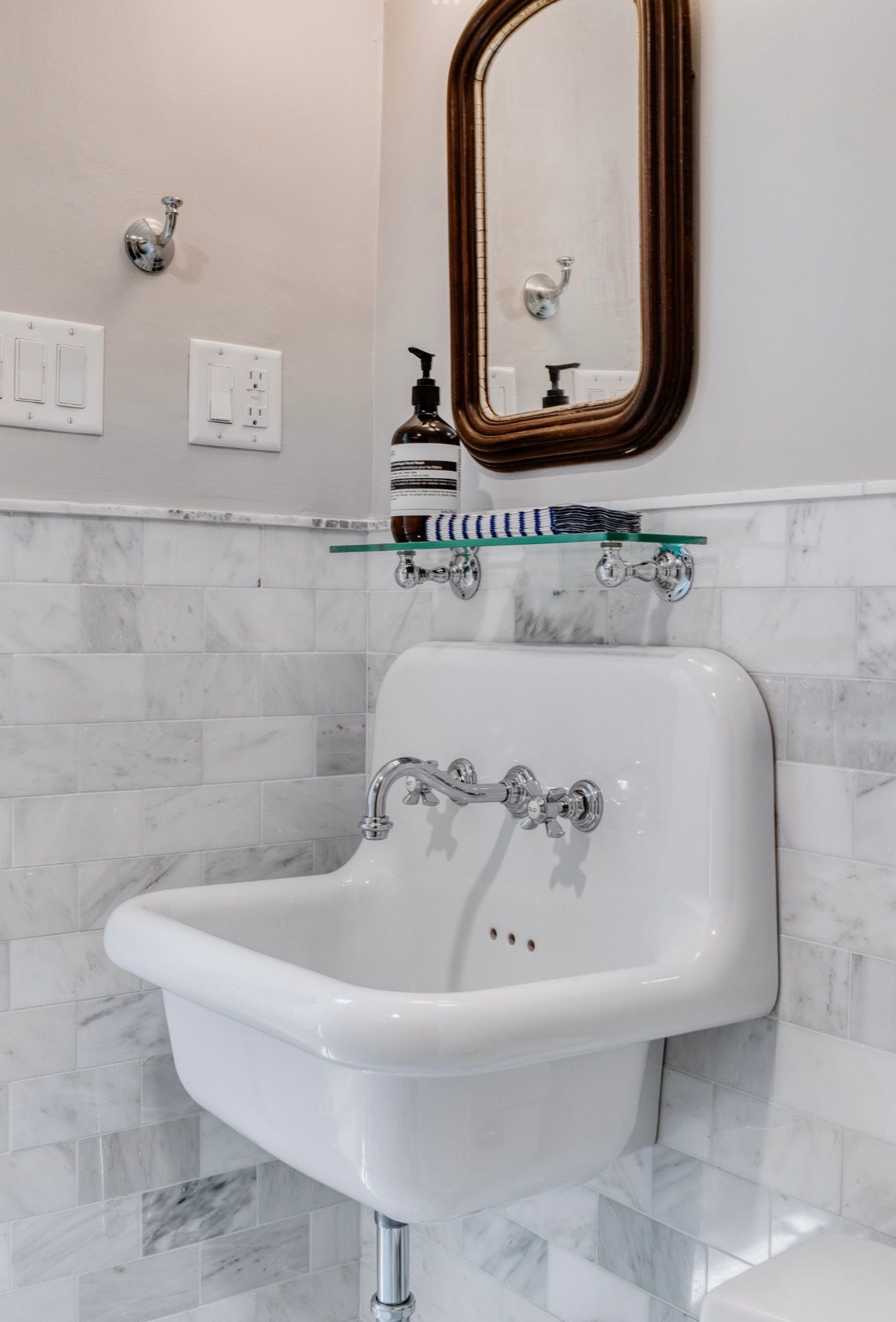 A bathroom with a sink and a mirror on the wall.