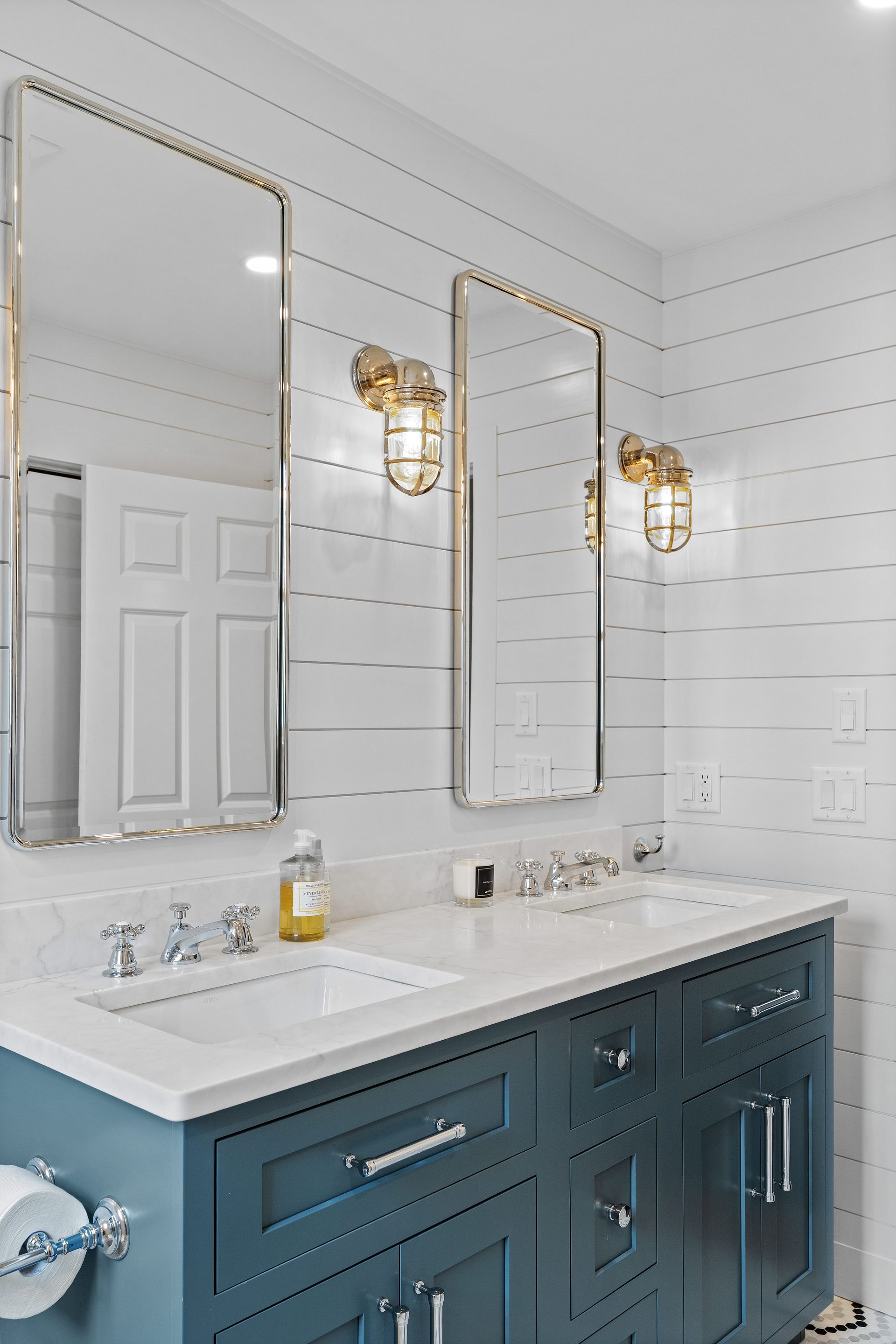 A bathroom with two sinks and two mirrors.